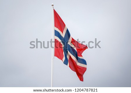 Norwegian flag waving on blue clear sky background