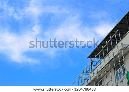 Steel frame for installation of billboards, blank background, bright sky clouds.