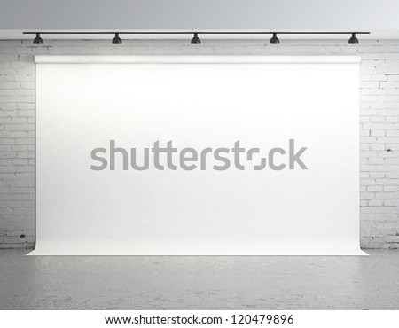 White backdrop in room with brick wall