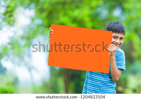 indian child holding empty poster