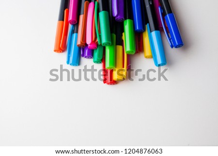 multi-colored felt-tip pens on the white isolated background.