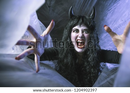 Halloween Beautiful young woman in witches or Demon costume