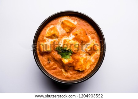 Paneer Butter Masala or Cheese Cottage Curry in serving a bowl or pan, served with or without roti and rice Royalty-Free Stock Photo #1204903552