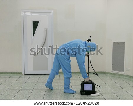 Inspector are testing dust inside the operating room with Particle Counter. Royalty-Free Stock Photo #1204929028