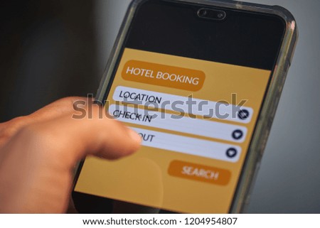 Online hotel booking and online travel concept. Male hands using smartphone for holiday vacation deal on mobile reservation app. Front view & close up. All screen graphics are made up with own design