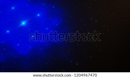 Blue and Green Laser Light Stars on a Black Background