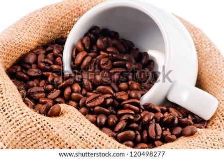 White cup in a bag of coffee beans