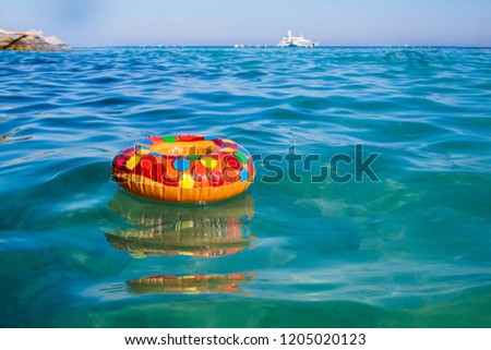 Toy swimming ring on the sea waves