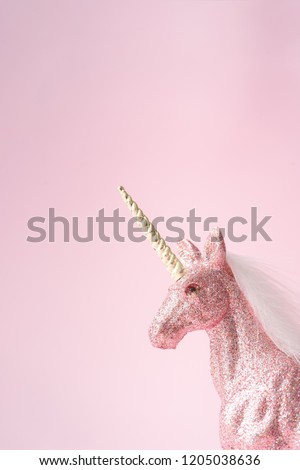 Pink glitter unicorn with gold horn. Magic surreal style. Minimal composition.