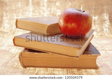Fresh red organic apple on a books