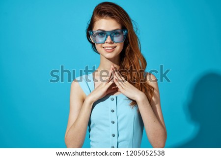 woman in blue glasses and blue dress                         