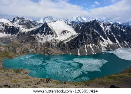 Beautiful view over turquoise color lake (lake, highland, peak, beauty world) Picturesque view near Alakul lake in Terskey Alatoo mountains, Tian-Shan, Karakol, Kyrgyzstan 