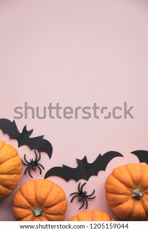 Halloween decorations on pastel pink background. flat lay, pumpkins, spiders and bats
