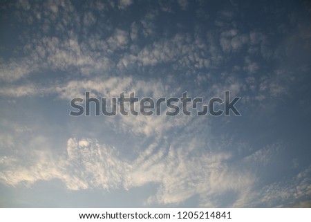 Abstract background of heavenly image. Fluffy clouds have built beautiful figures in the sky. The sun's rays illuminate the images of the sky with clouds.