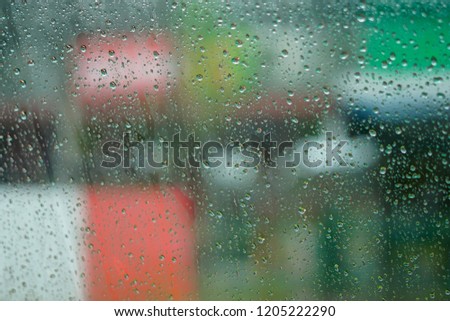 Water droplets on the car glass surface. after the rain fell by the window. background scenery outside blurred