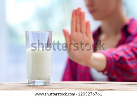A woman feels bad, has an upset stomach, bloating due to lactose intolerance. Dairy intolerant person. Health care concept. Lactose intolerance and dairy products Royalty-Free Stock Photo #1205276761