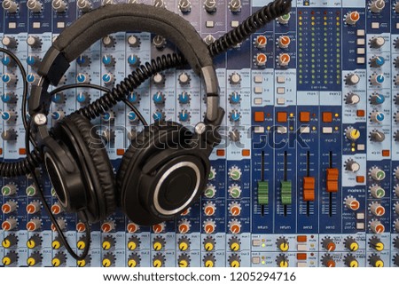 Headphones on table of mixing console