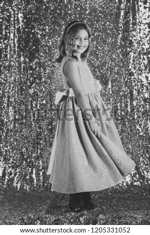 Little girl in fashionable dress, prom. Fashion and beauty, little princess. Look, hairdresser, makeup. Child girl in stylish glamour dress, elegance. Fashion model on silver background, beauty.