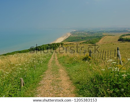 Path through the lush green fields on the cliffs of the French opal coast along North Sea 