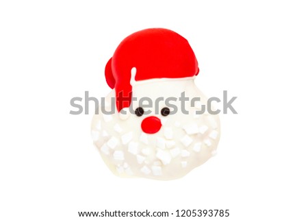 Santa Claus red hat donut with sugar flakes isolated on white background (Clipping path included) to celebrate Christmas holiday season, sweet or snack for special event celebration or new year party