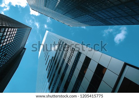 Up view in Financial District, Manhattan, New York. A perspective view at Manhattan skyscrapers on a sunny day.