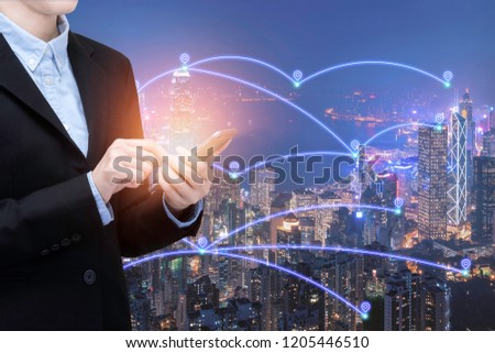 Asian business woman use smartphone technology in Smart city with communication network and big data system.