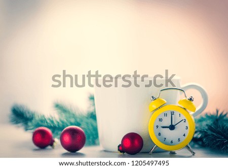 Alarm clock and cup with christmas decoration around