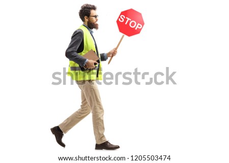 Full length shot of a man in a safety vest holding a stop traffic sign walking isolated on white background