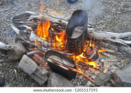 Cooking soup from a pike at the stake. The fire, pots and accessories.