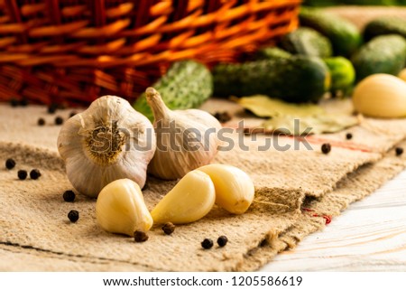 heads of garlic and brushed denticles on the table with a basket