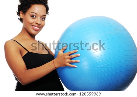 Pregnant woman exercises with big blue gymnastic ball
