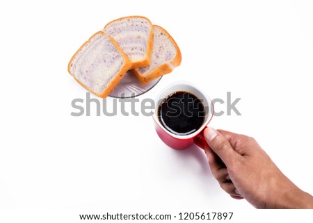 Hand  holding a red cup of hot black coffee and sliced bread on Glass plate isolated on white background.   