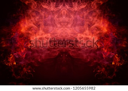 Fantasy print for clothes: t-shirts, sweatshirts. Thick colorful smoke of pink, red colors smoke in the form of a skull, monster, dragon on a black isolated background. Background from the smoke 