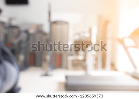 Abstract blur fitness gym with equipment for background.