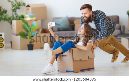 a happy young married couple moves to new apartment

