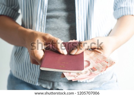Casual style woman holding passport and Thai banknotes, Travel concept, Thailand tourist