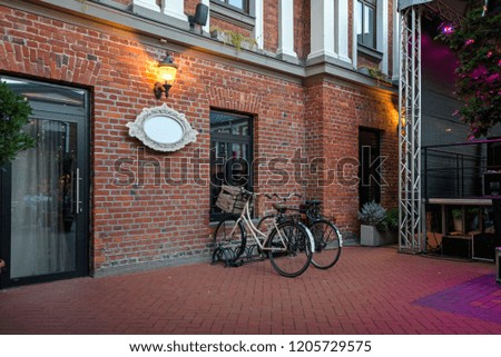 Two bicycles with wooden box or basket standing next to wall in old city. Romantic evening scene in old town. Concept of healthy lifestyle

