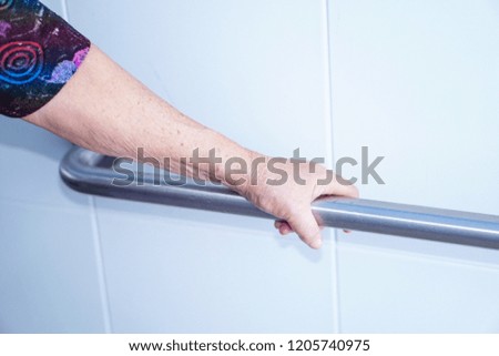 Asian senior or elderly old lady woman patient use toilet handle security in nursing hospital ward : healthy strong medical concept.
