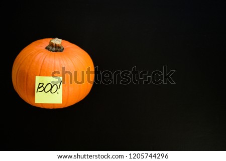 Pumpkin with boo word on black chalk board
