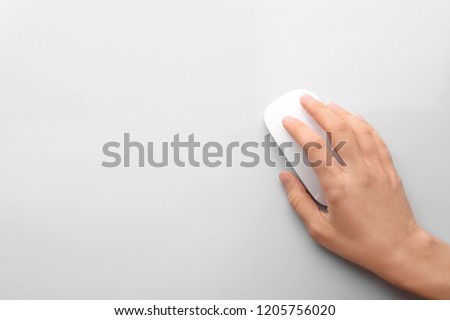Woman using computer mouse on white background, top view. Space for text Royalty-Free Stock Photo #1205756020