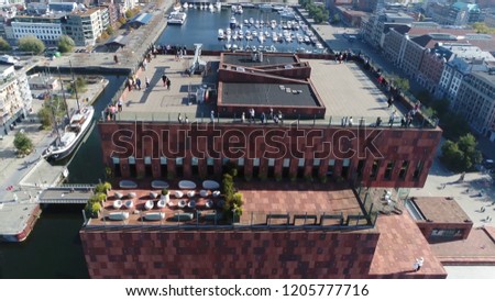 Aerial photo tall building roof in Belgium Antwerp located along the river Scheldt in Eilandje district showing people enjoying the beautiful weather of summer day Royalty-Free Stock Photo #1205777716
