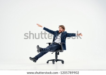 man spreads his arms sitting on a chair                          