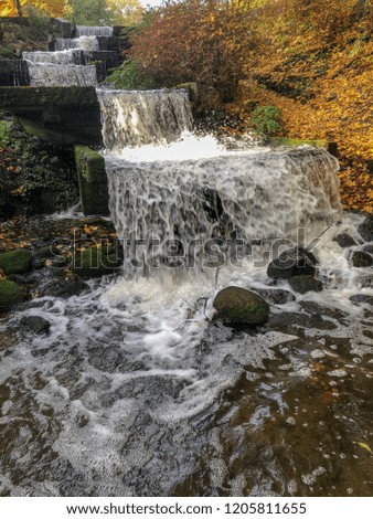 Waterfall in a central park in autumn