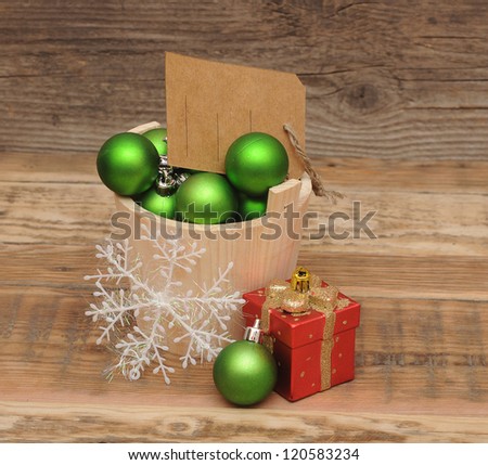 Christmas decoration with blank price tag on wooden plank