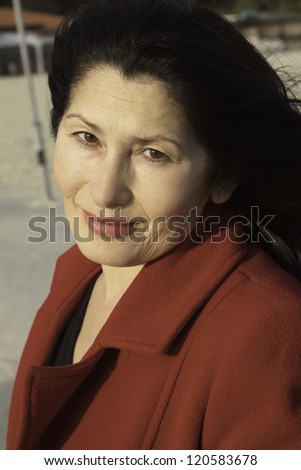 Portrait of the woman enjoying an autumn sunlight