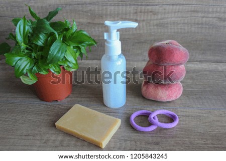 Bathroom accessories, Liquid soap, shower gel, hair elastics, peach. Green flowerpot