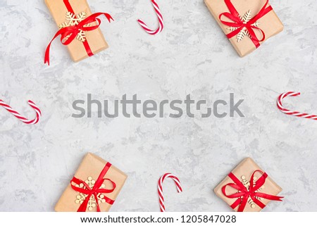 Christmas composition. Christmas decoration gifts, glitter, Christmas balls, candy, snowflakes on gray concrete  background. Flat lay, top view.