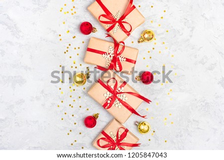Christmas composition. Christmas decoration gifts, glitter, Christmas balls, candy, snowflakes on gray concrete  background. Flat lay, top view.