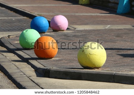 concrete balls on the sidewalk