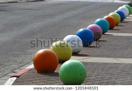 concrete balls on the sidewalk